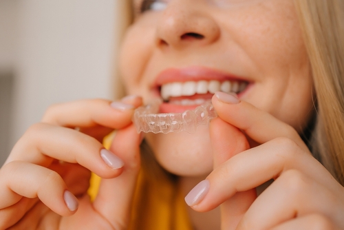 A,Close-up,Of,A,Young,Woman,Smiling,While,Holding,A